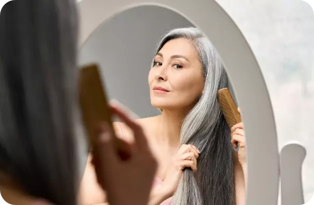 woman brushing grey hair