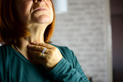 woman feeling thyroid gland